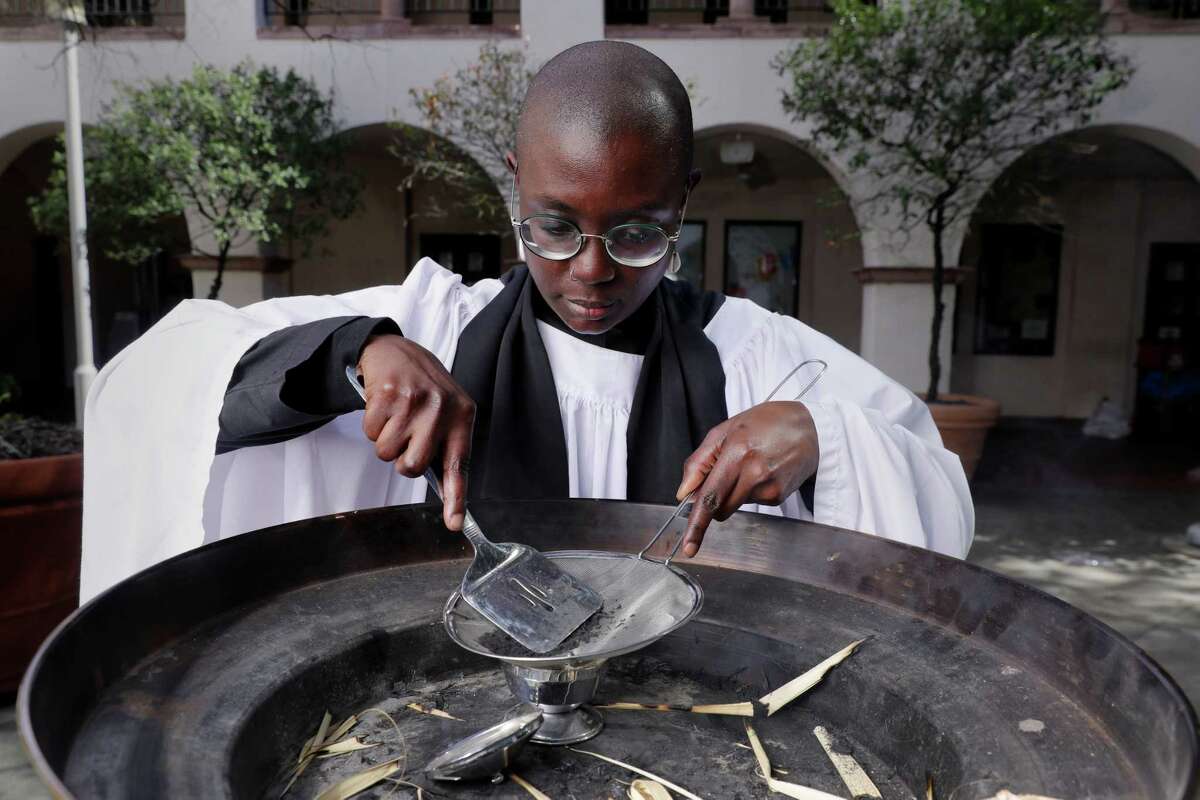 Rev. Ryan Hawthorne uses a spatula and seive to sift burnt palm leaves during a demonstration on how to produce ash for Ash Wednesday services, that will be administered curbside outside Palmer Memorial Episcopal Church Monday, Feb. 13, 2023 in Houston, TX.