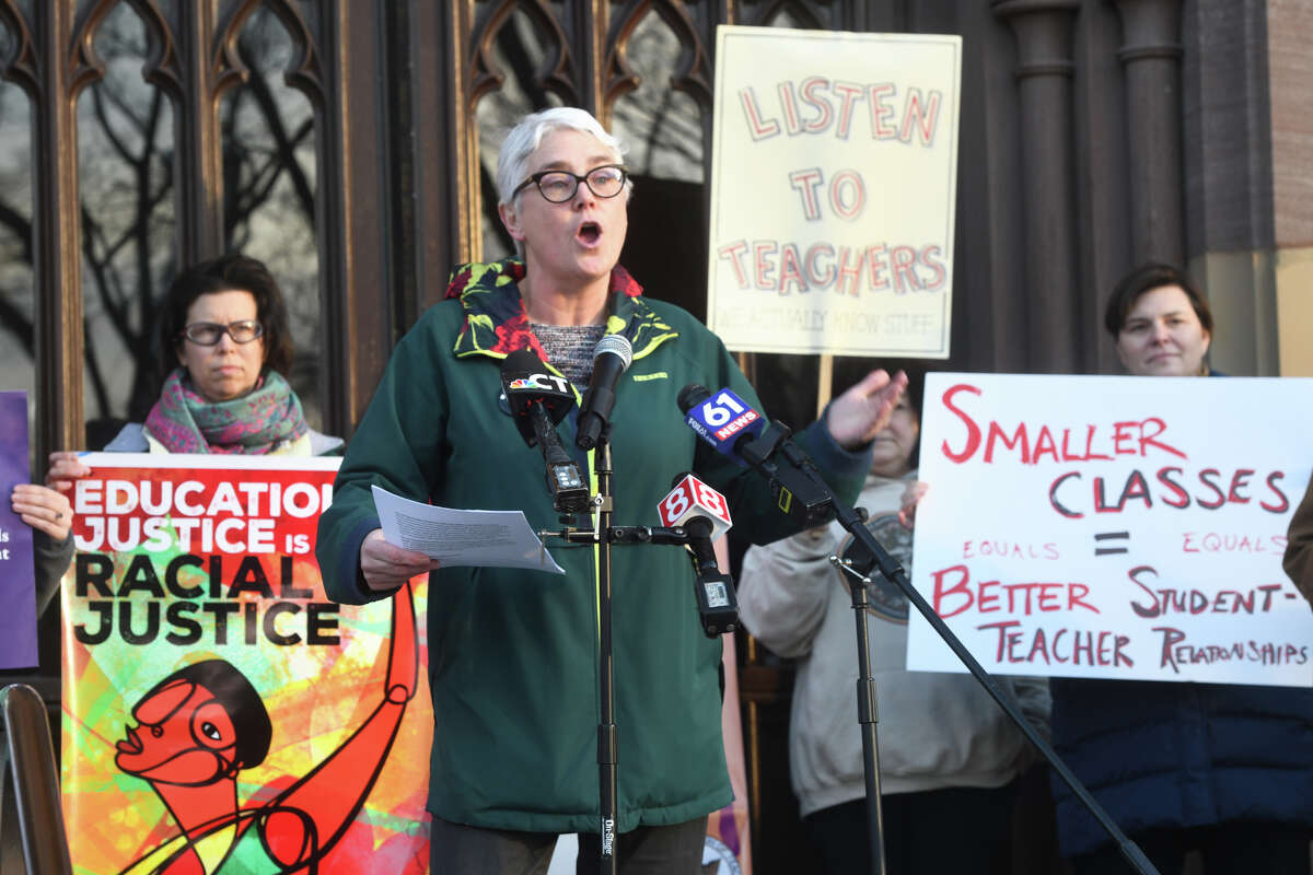 Leslie Blatteau of the New Haven Federation of Teachers leads a rally on the steps of New Haven City Hall Monday.