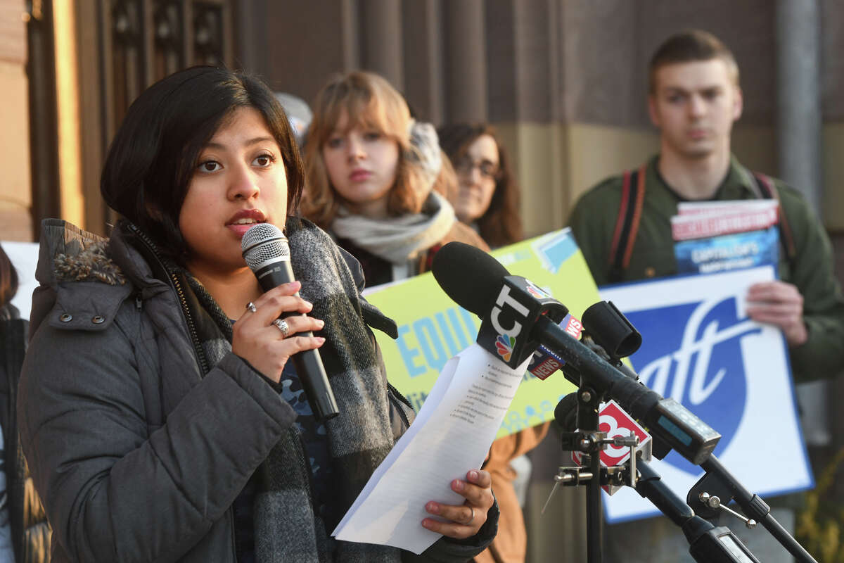 Allison Escobar, a student from High School in the Community, speaks during a rally on the steps of New Haven City Hall Monday.