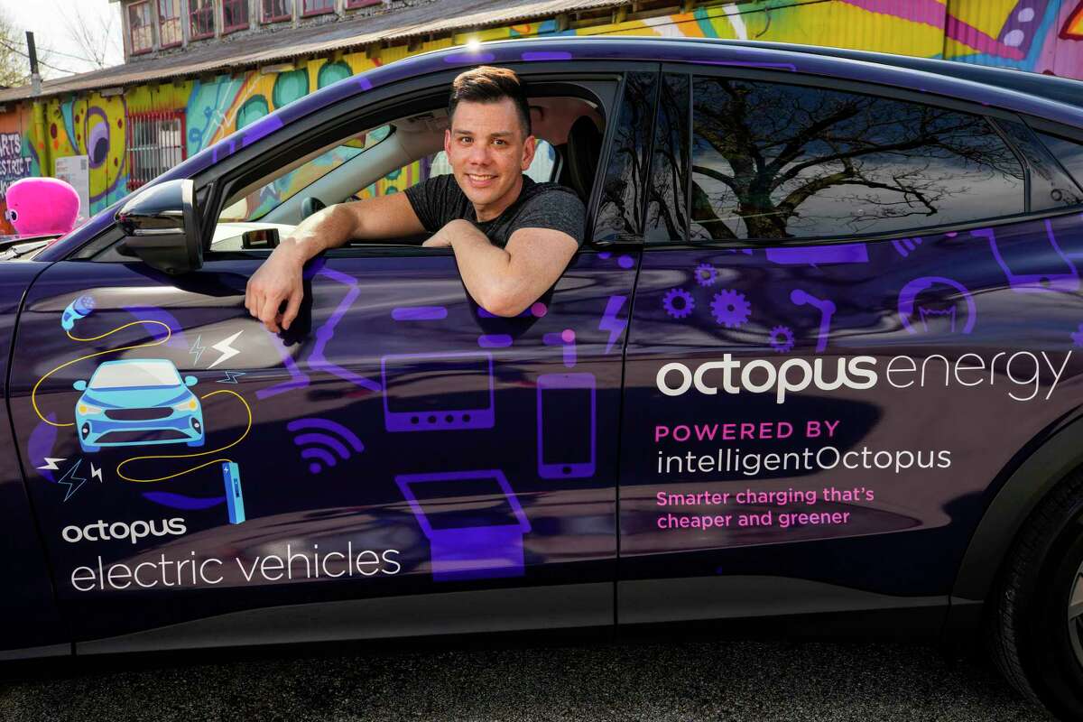 Michael Lee, CEO, Octopus Energy, poses for a portrait with a Ford Mach-E on Monday, Feb. 13, 2023 in Houston. Octopus Energy is debuting a unique electricity plan meant to help save electric vehicle owners money while reducing electricity use during times of high demand."