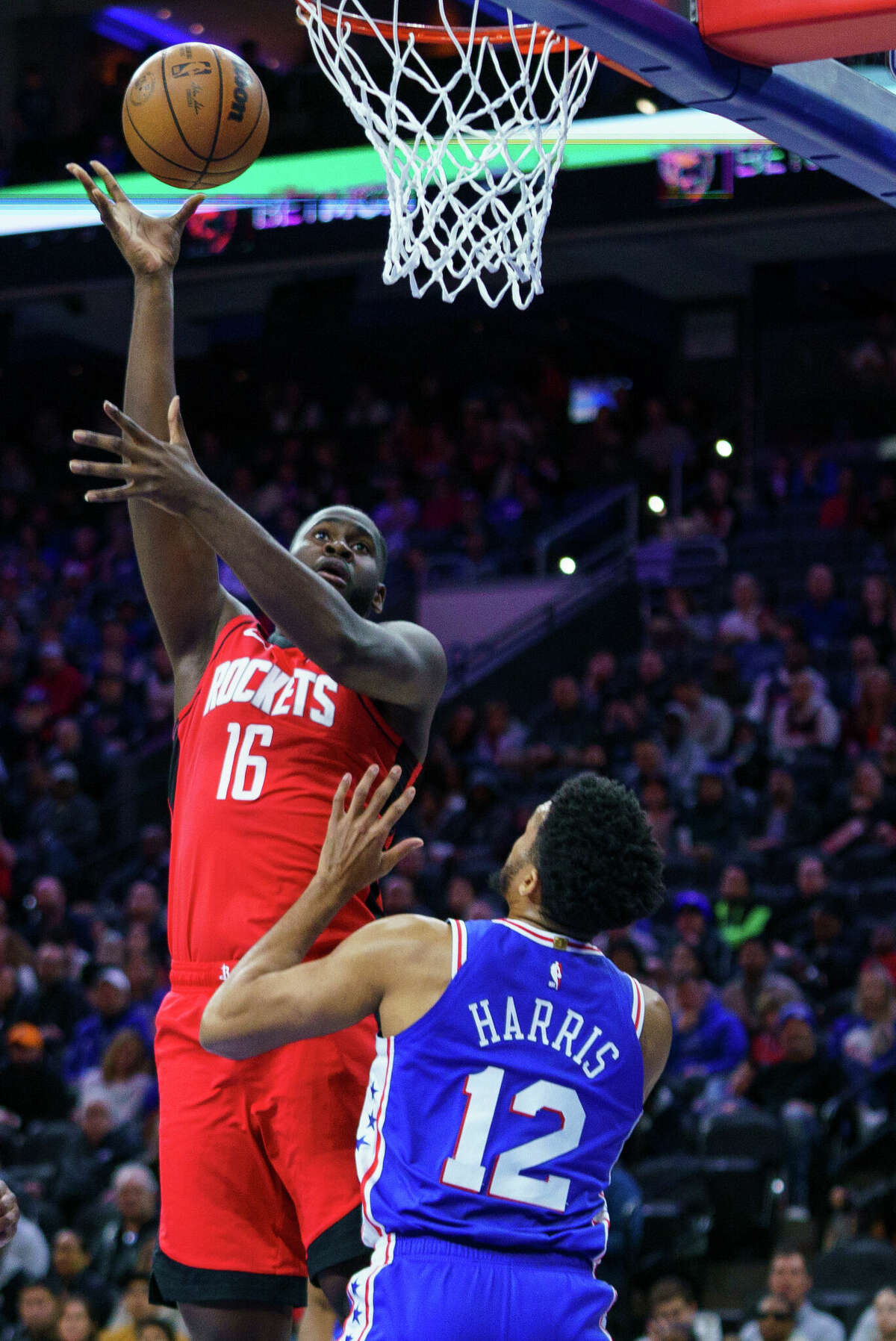 Houston Rockets' Daishen Nix, left, shoots the ball over Philadelphia 76ers' Tobias Harris, right, during the first half of an NBA basketball game, Monday, Feb. 13, 2023, in Philadelphia. (AP Photo/Chris Szagola)