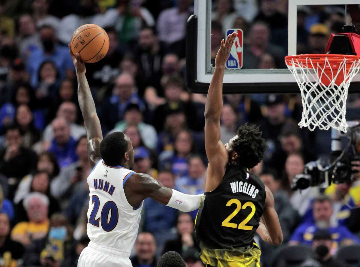 Andrew Wiggins (22) defends against Kendrick Nunn (12) in the second half as the Golden State Warriors played the Washington Wizards at Chase Center in San Francisco, Calif., on Monday, February 13, 2023.