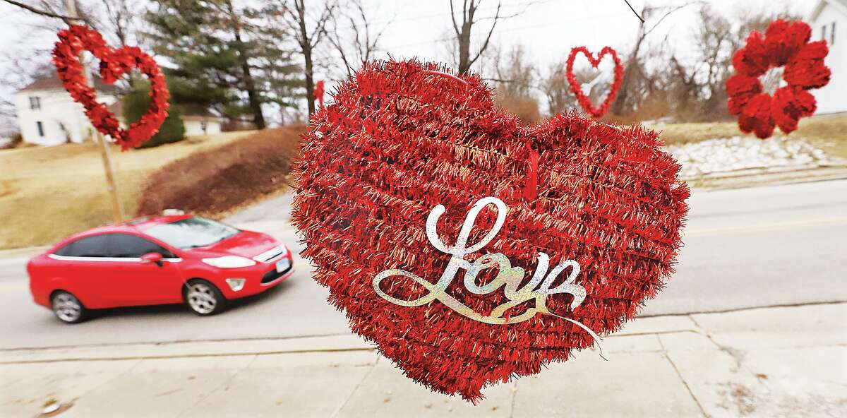 John Badman|The Telegraph Love was in the air Tuesday and hanging from a tree as motorists pass heart shapes during a drive on Brown Street in Alton.
