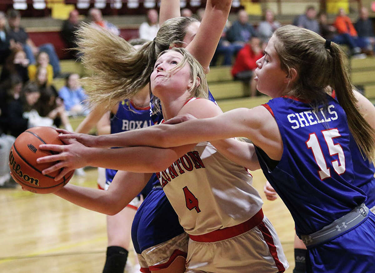 Staunton's Ele Feldmann (4) splits defenders and draws a foul on Roxana's Abby Gehrs (15) in the first half Monday night in a EA-WR Class 2A Regional semifinal at Memorial Gym in Wood River.