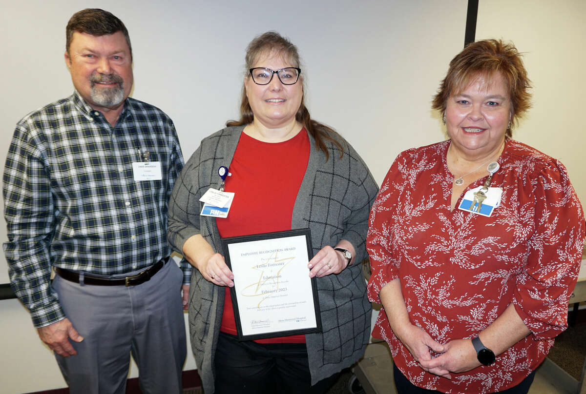 Leslie Forrester of Education, center, is Alton Memorial Hospital’s February Employee of the Month. She received the honor Feb. 14 from AMH President Dave Braasch and Lisa Blaes, manager of Education.