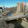 Pedestrians walk across the decrepit footbridge spanning the Rippowam River between Mill River Park and Mill River Playground in Stamford, Conn. Tuesday, Feb. 14, 2023. The bridge will close on Feb. 20 as construction work begins on a temporary replacement, just north of the existing structure.