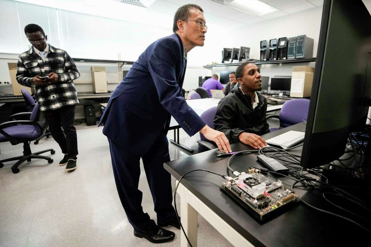 Lijun Qian, Ph.D., left, works with Jovan Cain, a graduate student from Dallas, in the Deep Learning Lab at Prairie View A&M University on Tuesday, Feb. 14, 2023 in Prairie View. NASA is providing $1.5 million to Prairie View A&M to develop an AI chat bot. It will be like ChatGPT but made specifically for NASA data.