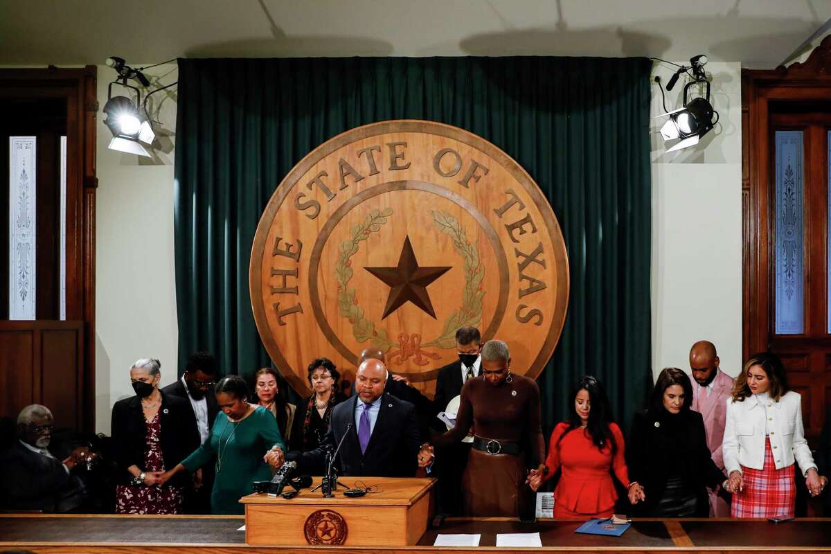 Rep. Carl Sherman leads a closing prayer during a press conference held by members of the Texas Legislative Black Caucus Tuesday morning, Feb. 14, 2023. They spoke out against Gov. Greg Abbott's order asking state agencies to eliminate diversity policies from their hiring practices.