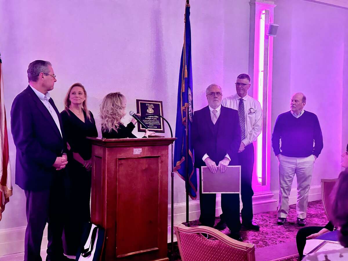 Dan Fisher, Deb Tartaglino and Karen Thomas, pictured at the podium, were honored by the Torrington Elks Club Feb. 11 with their annual awards. 