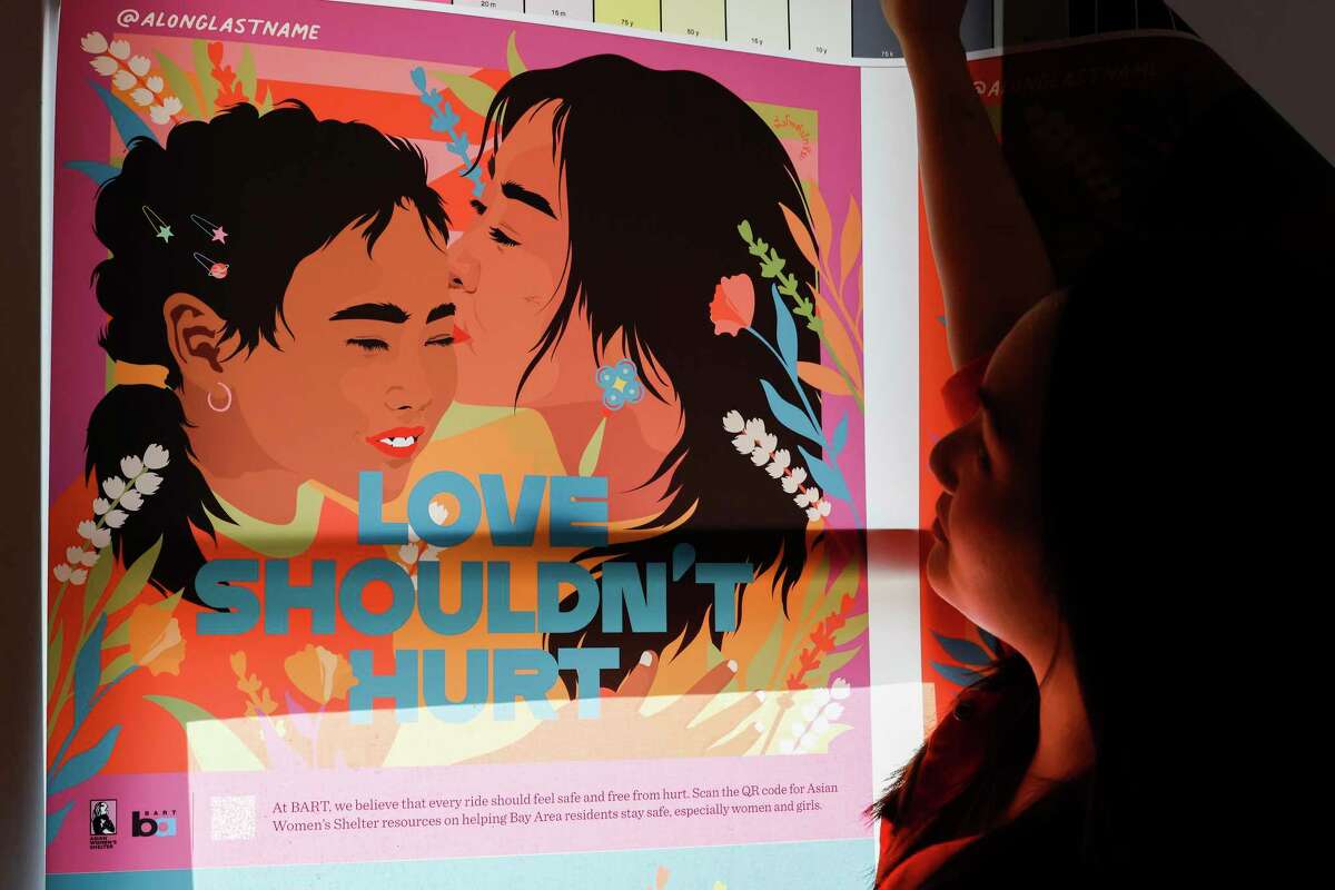 New York-based artist Amanda Phingbodhipakkiya looks over a proof from her "Let's Talk About Us" series, which addresses the topic of domestic violence, and will be on display starting Wednesday in BART stations around the Bay Area.