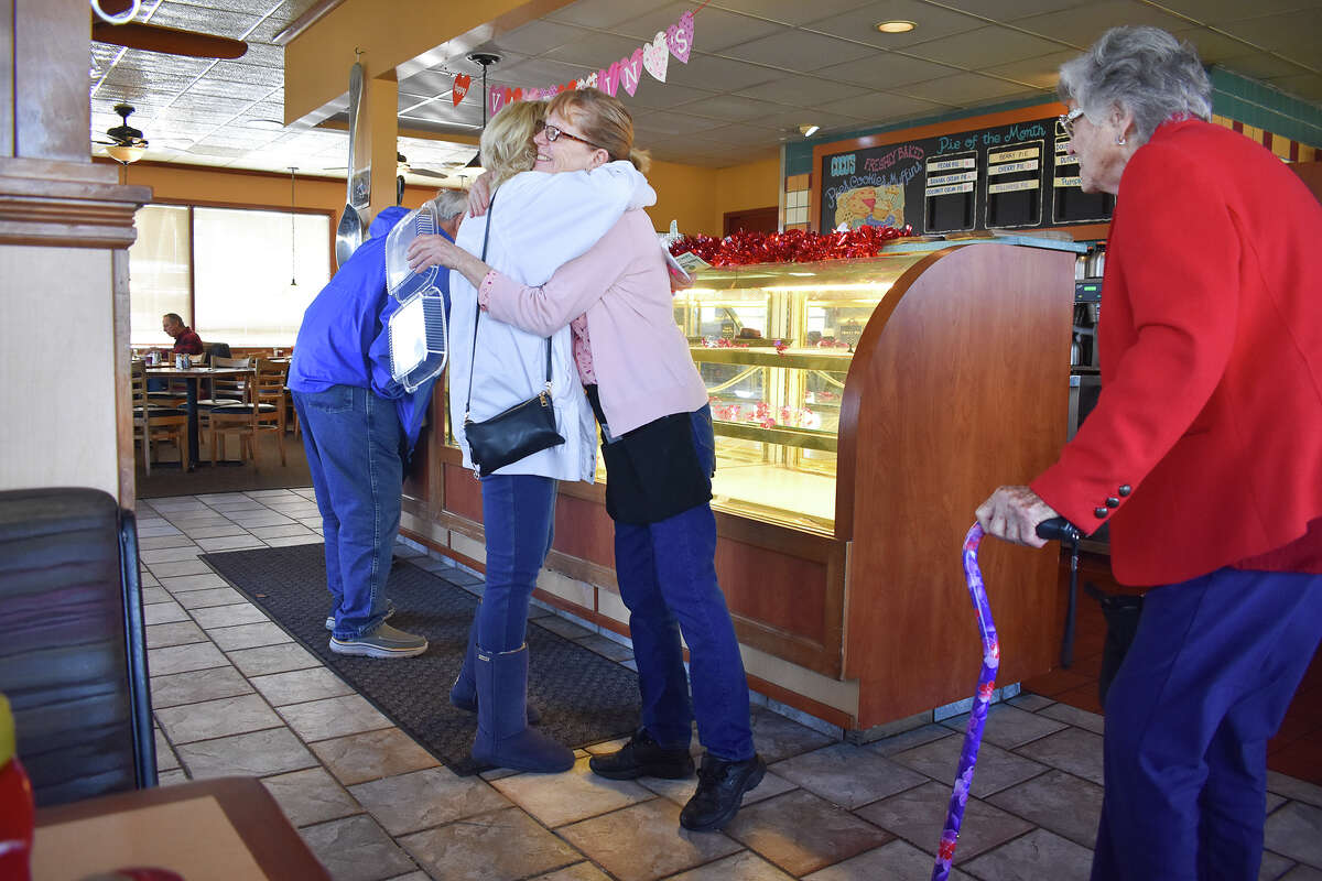 A customer exchanges a hug with a server at the Pismo Beach Coco's on Feb. 14, 2023. The Central Coast location, the northernmost in the Southern California-based chain, is closing for good after more than a quarter century.