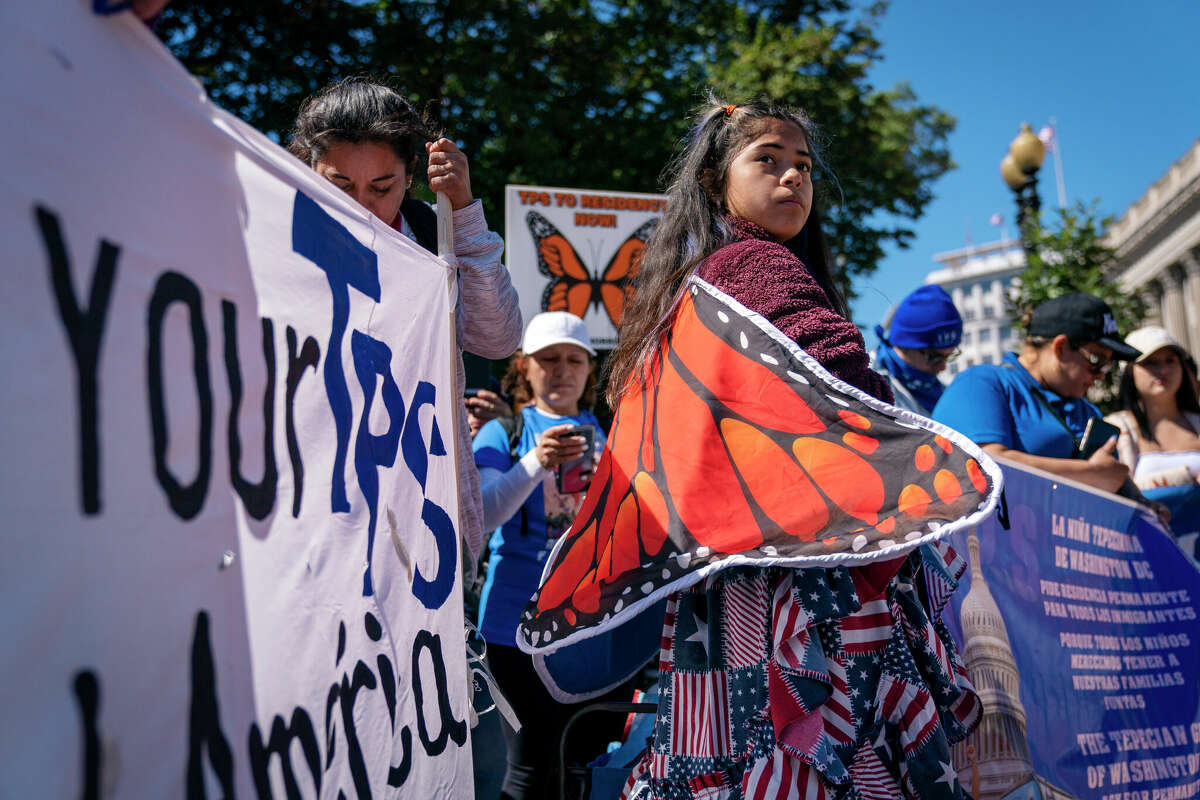 Marilyn Miranda, 12, of Washington, protests outside the White House in 2022 for an extension of Temporary Protected Status for migrants from some nations. A federal appeals court has blocked a ruling that had upheld President Donald Trump's deportation plans.