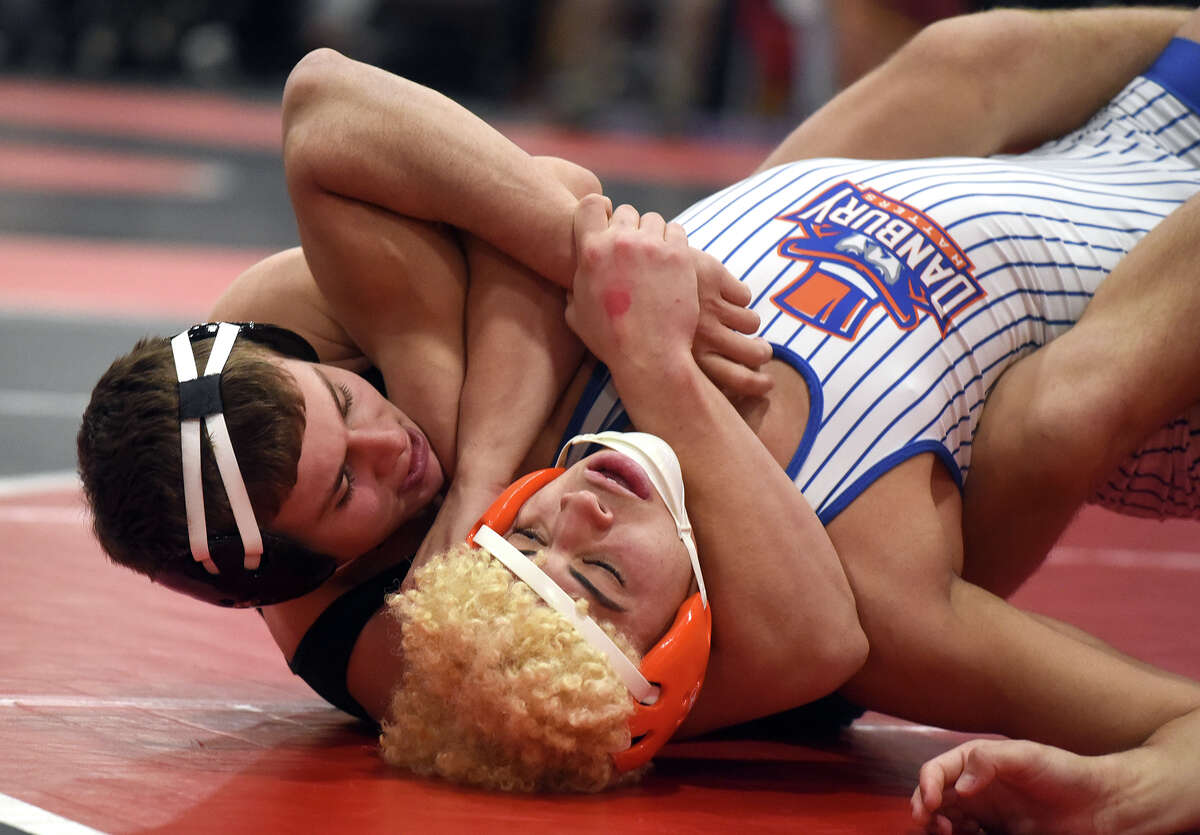 New Canaan's Cael Wilderman (left) controls Danbury's Chris Luna during the 152-pound quarterfinals at the FCIAC wrestling tournament in New Canaan on Friday, Feb. 10, 2023.