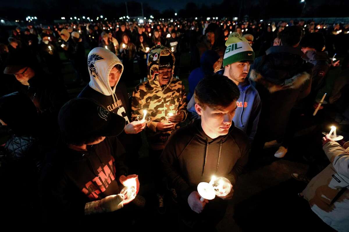 Mourners attend a candlelight vigil for Alexandria Verner at the Clawson High School football field in Clawson, Mich., Tuesday, Feb. 14, 2023. Verner was among the students killed after a gunman opened fire on the campus of Michigan State University Monday night.