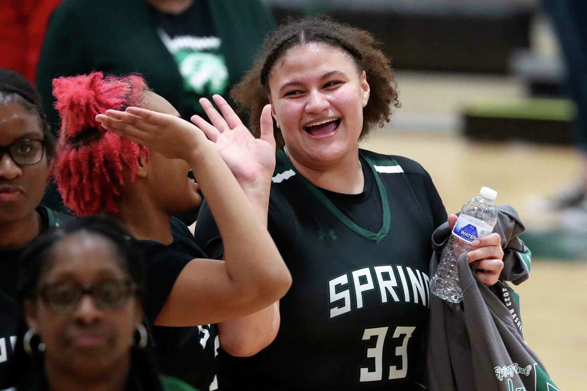 Spring's Avery Wesley (33) gets a high-five from teammate Jazlyn Martinez (32) after making the game-winning basket with seconds remaining to give the Lions a 45-43 win over Conroe during a Region II-6A bi-district high school basketball game at West Fork High School, Tuesday, Feb. 14, 2023, in Kingwood.