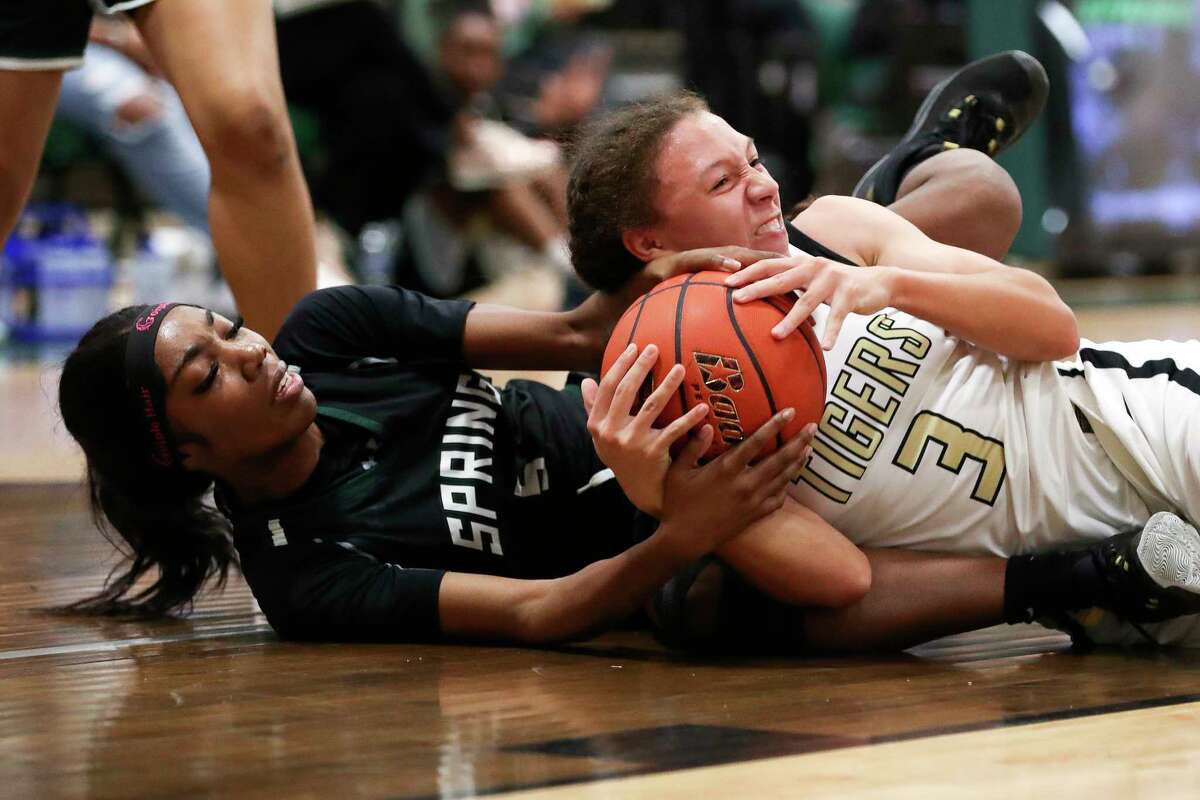 Conroe's Alisa Sneed (3) battles for a loose ball against Conroe's Ladonna Brown (5) during the first quarter of a Region II-6A bi-district high school basketball game at West Fork High School, Tuesday, Feb. 14, 2023, in Kingwood.