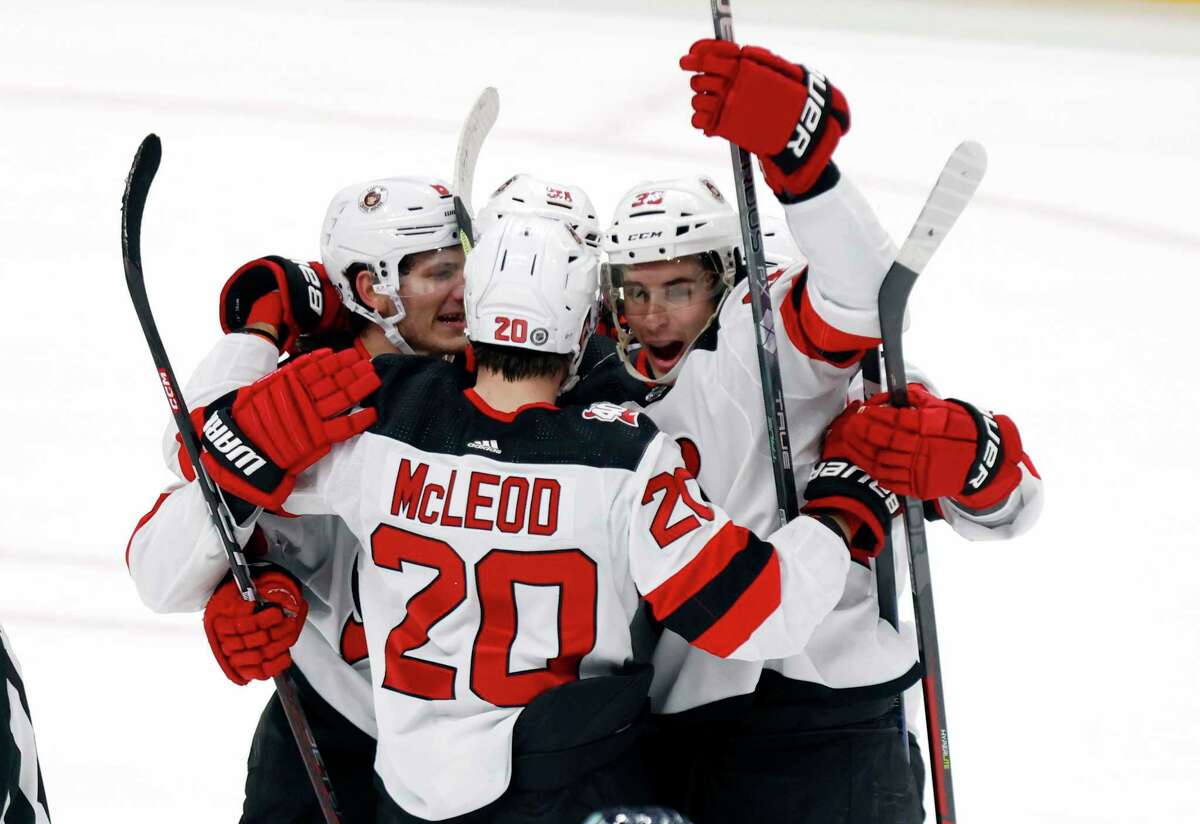 New Jersey defenseman Ryan Graves (right) celebrates his game-winning goal against the Blue Jackets.