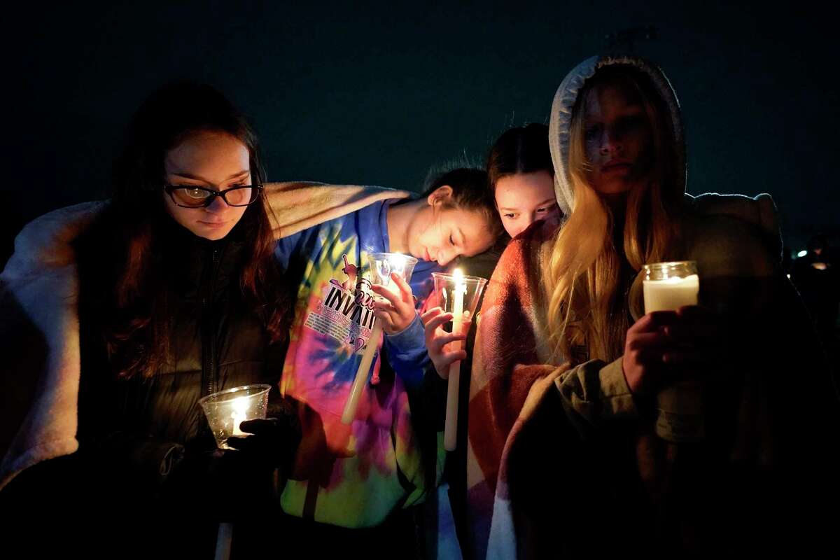 Mourners attend a candlelight vigil for Alexandria Verner at the Clawson High School football field in Clawson, Mich., Tuesday, Feb. 14, 2023. Verner was among the students killed after a gunman opened fire on the campus of Michigan State University Monday night.