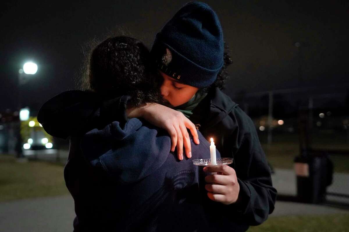 Mourners attend a candlelight vigil for Alexandria Verner at the Clawson High School football field in Clawson, Mich., Tuesday, Feb. 14, 2023. Verner was among the students killed after a gunman opened fire on the campus of Michigan State University Monday night.