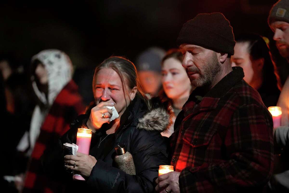 Mourners attend a candlelight vigil for Alexandria Verner at the Clawson High School football field in Clawson, Mich., Tuesday, Feb. 14, 2023. Verner was among the students killed after a gunman opened fire on the campus of Michigan State University Monday night.