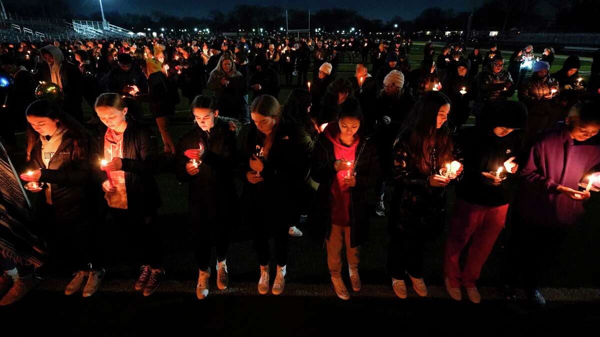 Mourners attend a candlelight vigil for Alexandria Verner at the Clawson High School football field in Clawson, Mich., Tuesday, Feb. 14, 2023. Verner was among the students killed after a gunman opened fire on the campus of Michigan State University Monday night.