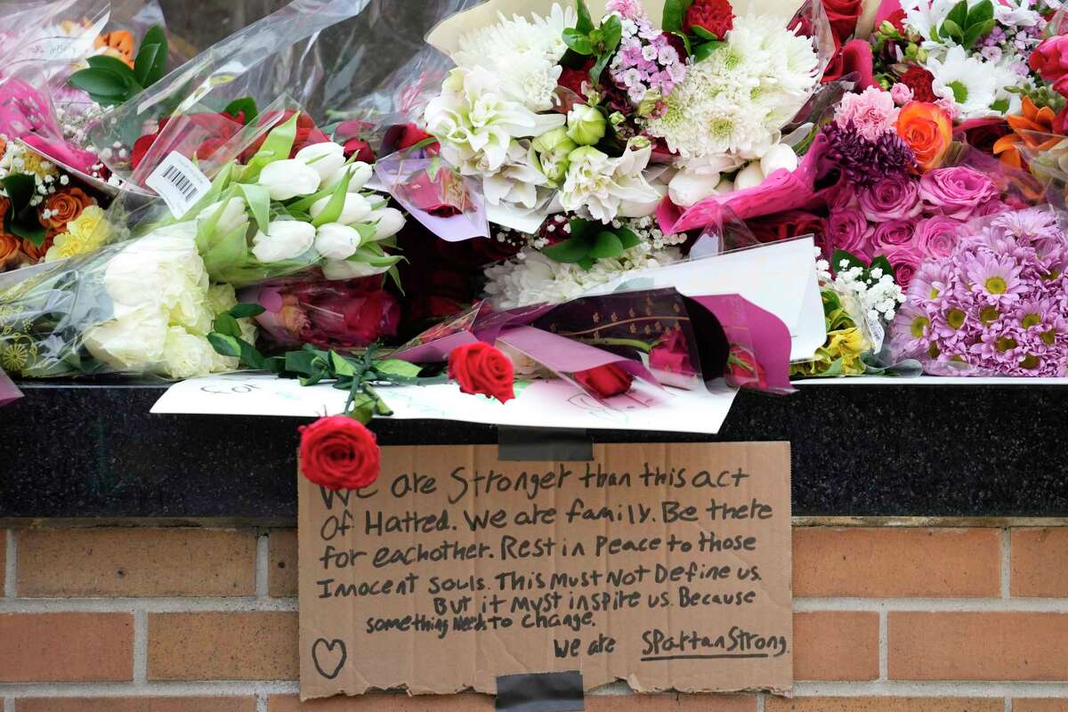 Flowers are left at the Spartan Statue on the grounds of Michigan State University, in East Lansing, Mich., Tuesday, Feb. 14, 2023. A gunman killed several people and wounded others at Michigan State University. Police said early Tuesday that the shooter eventually killed himself.