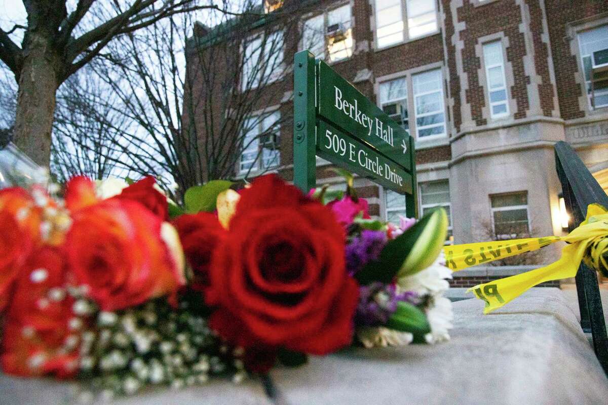 Flowers placed by mourners lie outside of Berkey Hall, where a mass shooting happened the night before at Michigan State University, in East Lansing, Mich., Tuesday, Feb. 14, 2023. (Brice Tucker/mlive.com/The Flint Journal via AP)