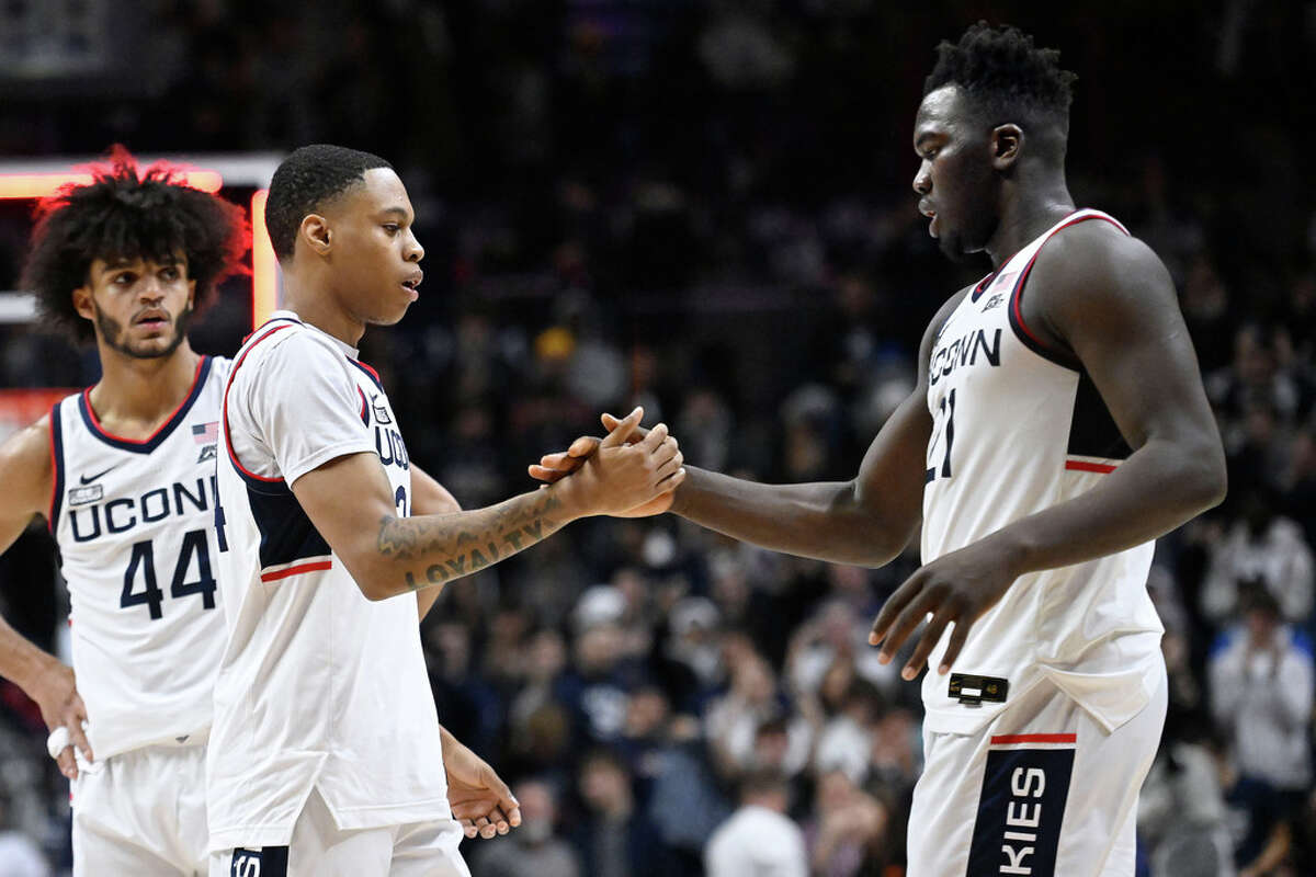 Jordan Hawkins and Adama Sanogo shake hands at the end of UConn's game against Oklahoma State, Thursday, Dec. 1, 2022, in Storrs.