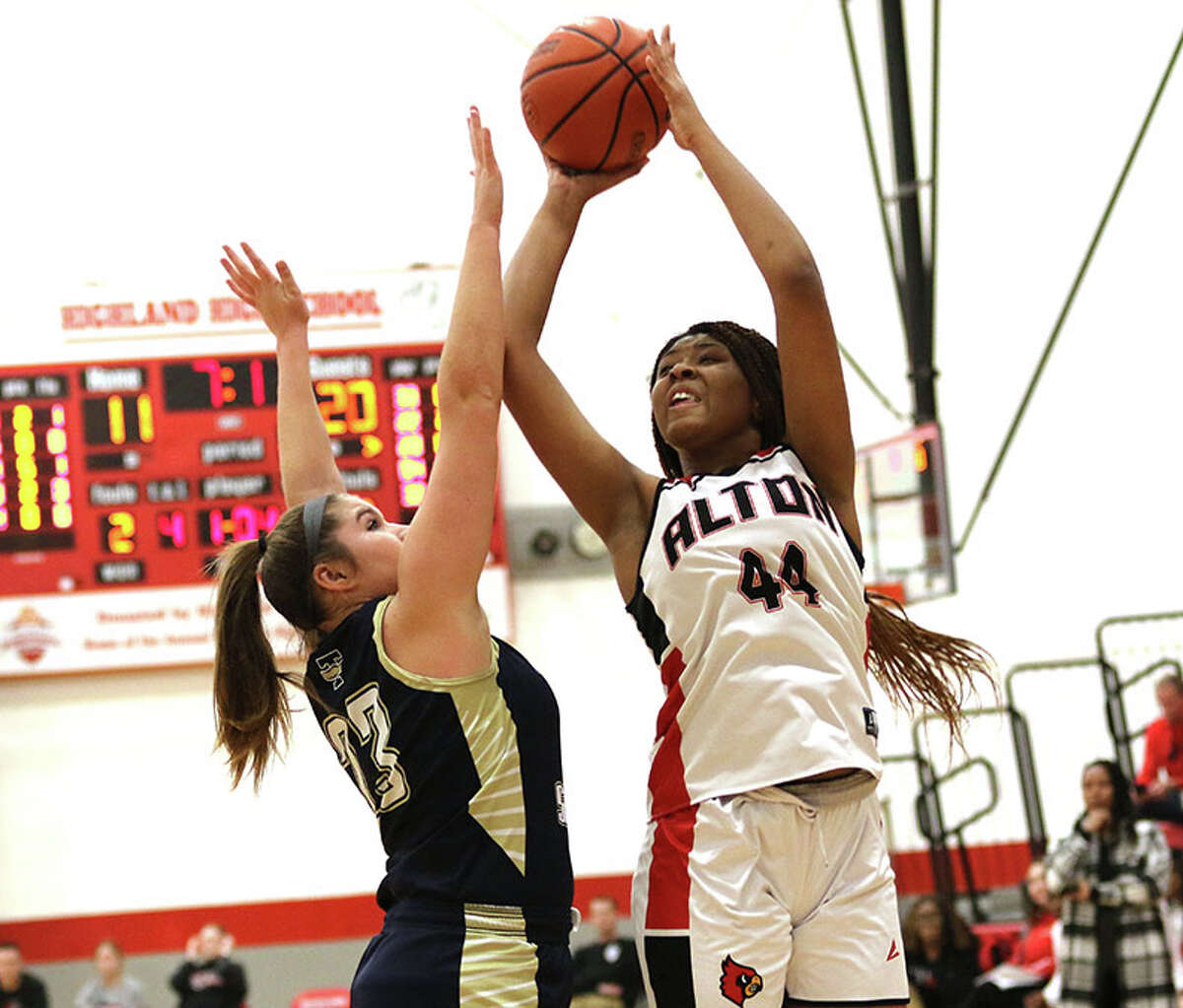 Alton's Jarius Powers (44) shoots over Teutopolis' Kaylee Niebrugge in a game at the Highland Tournament in January. The Redbirds moved their record to 30-1 Tuesday with a win over Granite City in the Alton Class 4A Regional.