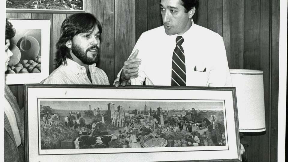 Artist Jesse Trevino, from left, presents a reproducitdon of one of his murals to then-Mayor Henry Cisneros. The men grew up on the West Side and remained friends. Trevino died Monday.  