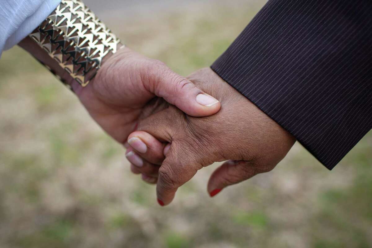 Cynthia Cole, a union leader, left, holds the hand of fellow civil rights activist Tammie Lang Campbell after a press conference Wednesday, Feb. 15, 2023, at a Kroger store in Missouri City. Activists said a white male customer had verbally assaulted a Black store manager using racial slurs. Kroger said they banned the man from that store.