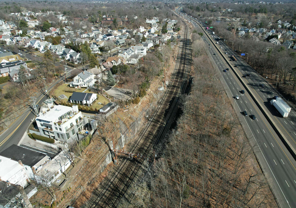 Train tracks pass through central Greenwich parallel to I-95 in Greenwich, Conn. Wednesday, Feb. 15, 2023. Desegregate CT is pitching a housing concept in Greenwich that would give state funding to communities that create designated "transit-oriented' districts.