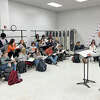 Composer Alan Stein, right, works with the Edwardsville High School Choir during his visit in December. Stein talked about how he put "Sound of the World," a poem by EHS sophomore Callie Abney, to music. The choir will perform the song on Feb. 21.