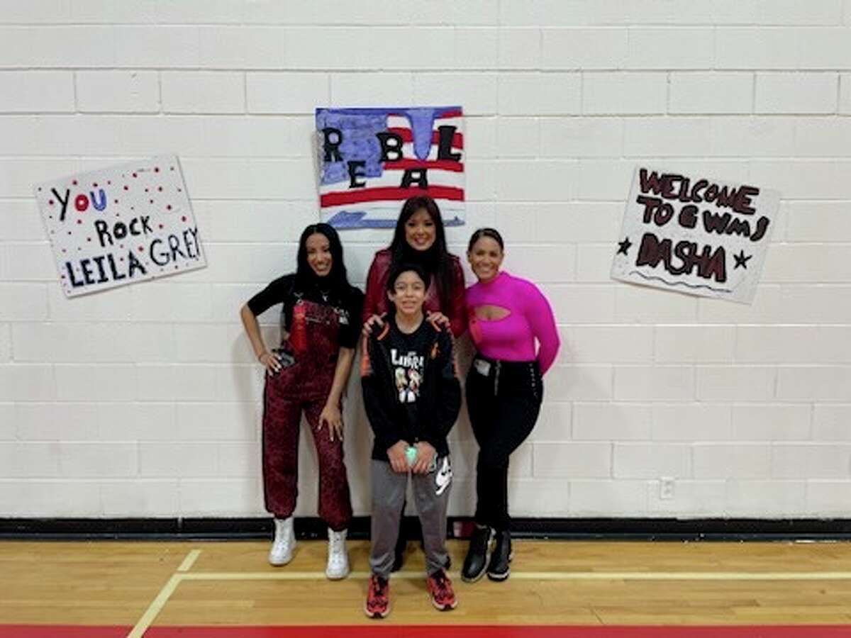 George Washington Middle School seventh-grade student Cesar Apac is pictured with AEW women's wrestlers Leila Grey, Rebel and Dasha Kuret on Wednesday, Feb. 15, 2023.