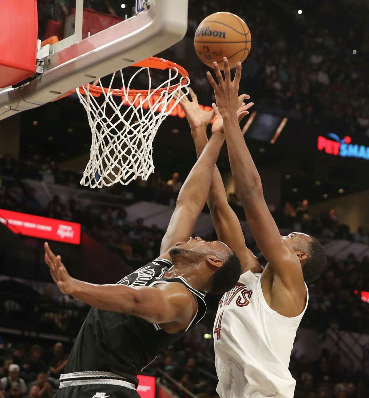 Spurs’ Charles Bassey (28) fights for a rebound against Cleveland Cavaliers’ Evan Mobley (04) at the AT&T Center on Monday, Dec. 12, 2022.