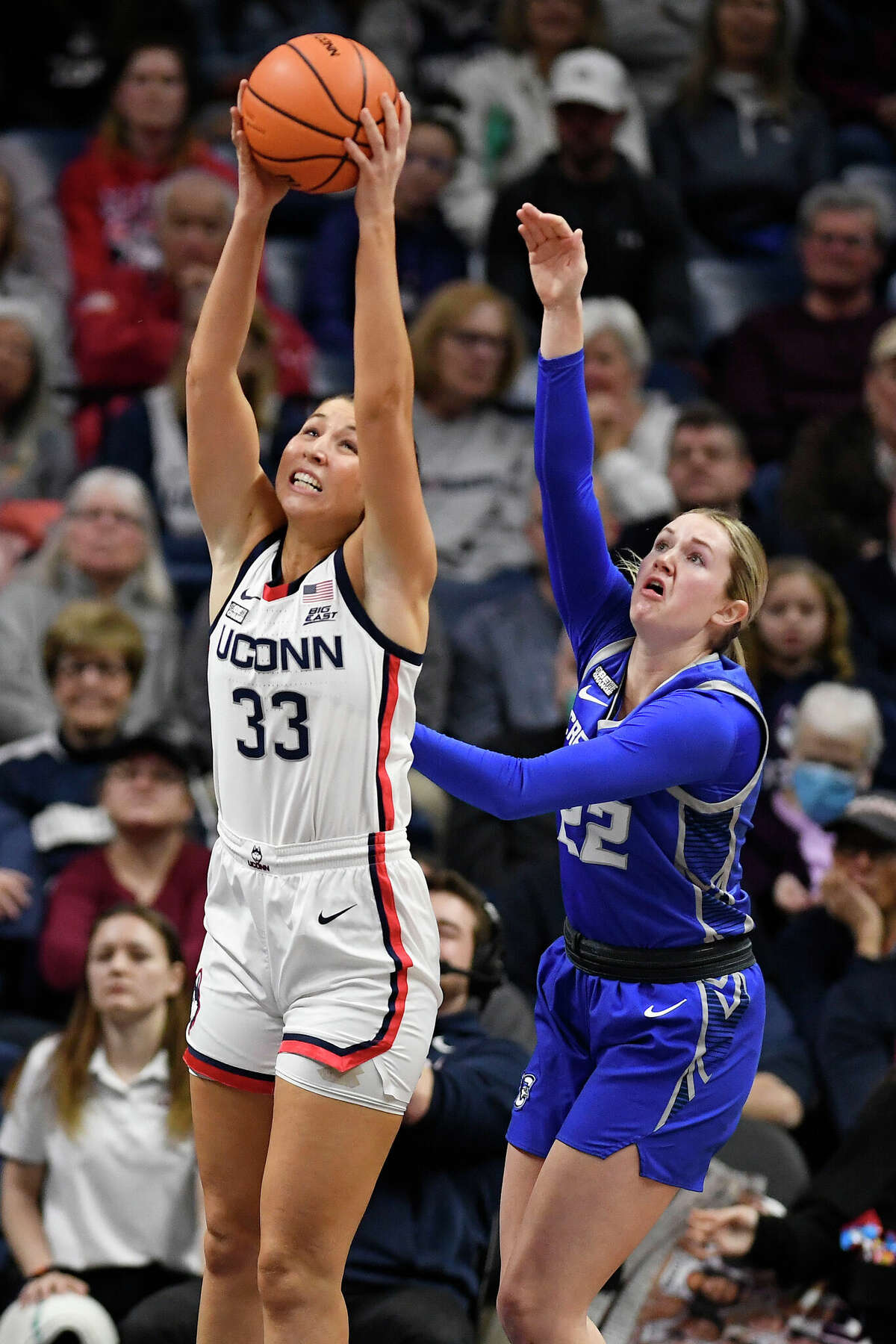 UConn's Caroline Ducharme (33) pulls in a rebound next to Creighton's Carly Bachelor (22) during the first half of an NCAA college basketball game Wednesday, Feb. 15, 2023, in Storrs, Conn. (AP Photo/Jessica Hill)