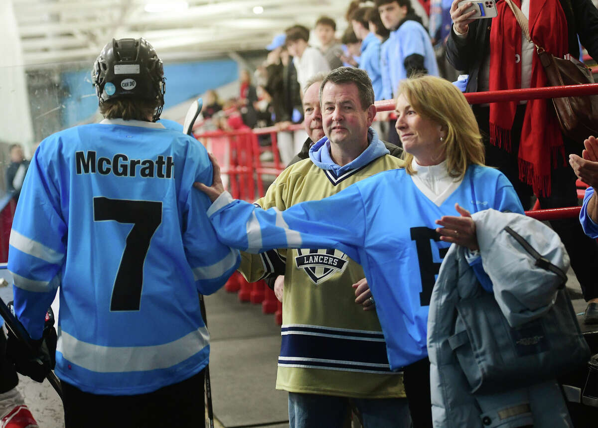 Kevin and Maggie McGrath, parents of deceased Fairfield Prep hockey player James McGrath, greet Prep players as they take the ice in jerseys bearing their son's name and number for their game with Notre Dame of Fairfield at The Wonderland of Ice in Bridgeport, Conn. on Wednesday, February 15, 2023.
