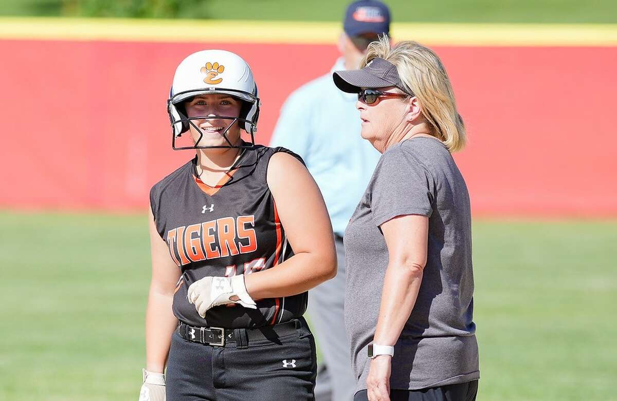 Edwardsville assistant coach Donna Farley, right, with Lexie Griffin at first base during the Class 4A Pekin Sectional championship game in 2022.