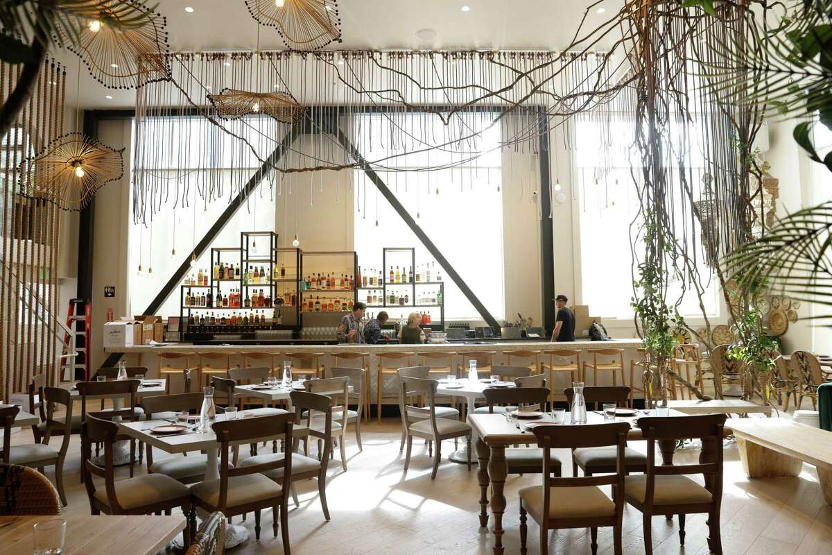 Ropes, rattan and greenery decorate the grand dining room at Copra in San Francisco.