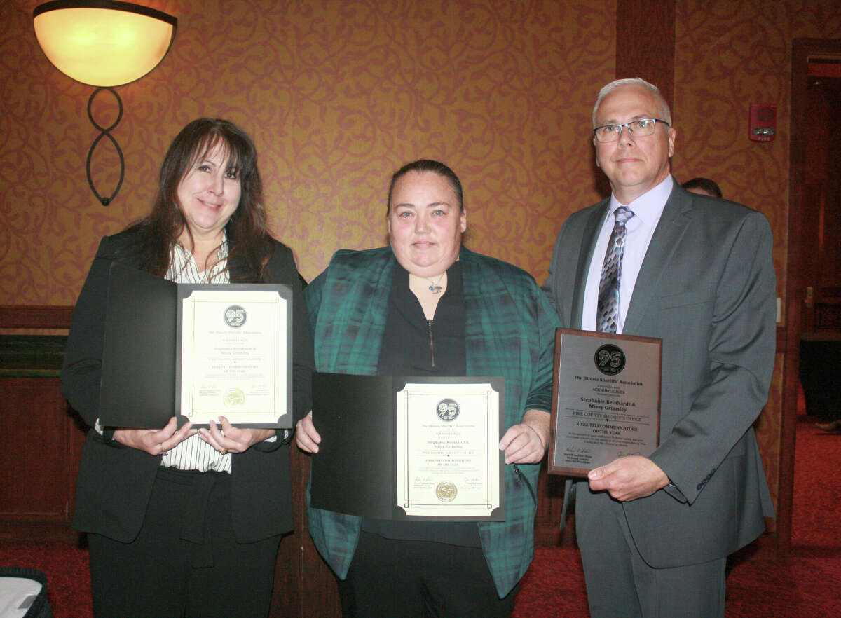 Stephanie Reinhardt (from left), Missy Grimsley and Pike County Sheriff David Greenwood hold the 2022 Telecommunicator of the Year award Reinhardt and Grimsley were given by the Illinois Sheriffs' Association.