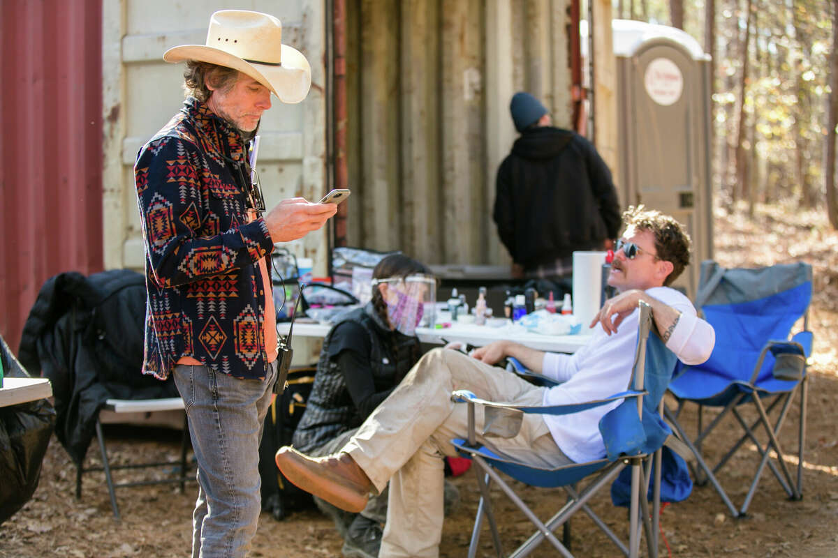 Executive producer Cary Wayne Moore of Alvin checks to see if the day's shooting of "The Integrity of Joseph Chambers " is finished as actor Clayne Crawford takes a break.