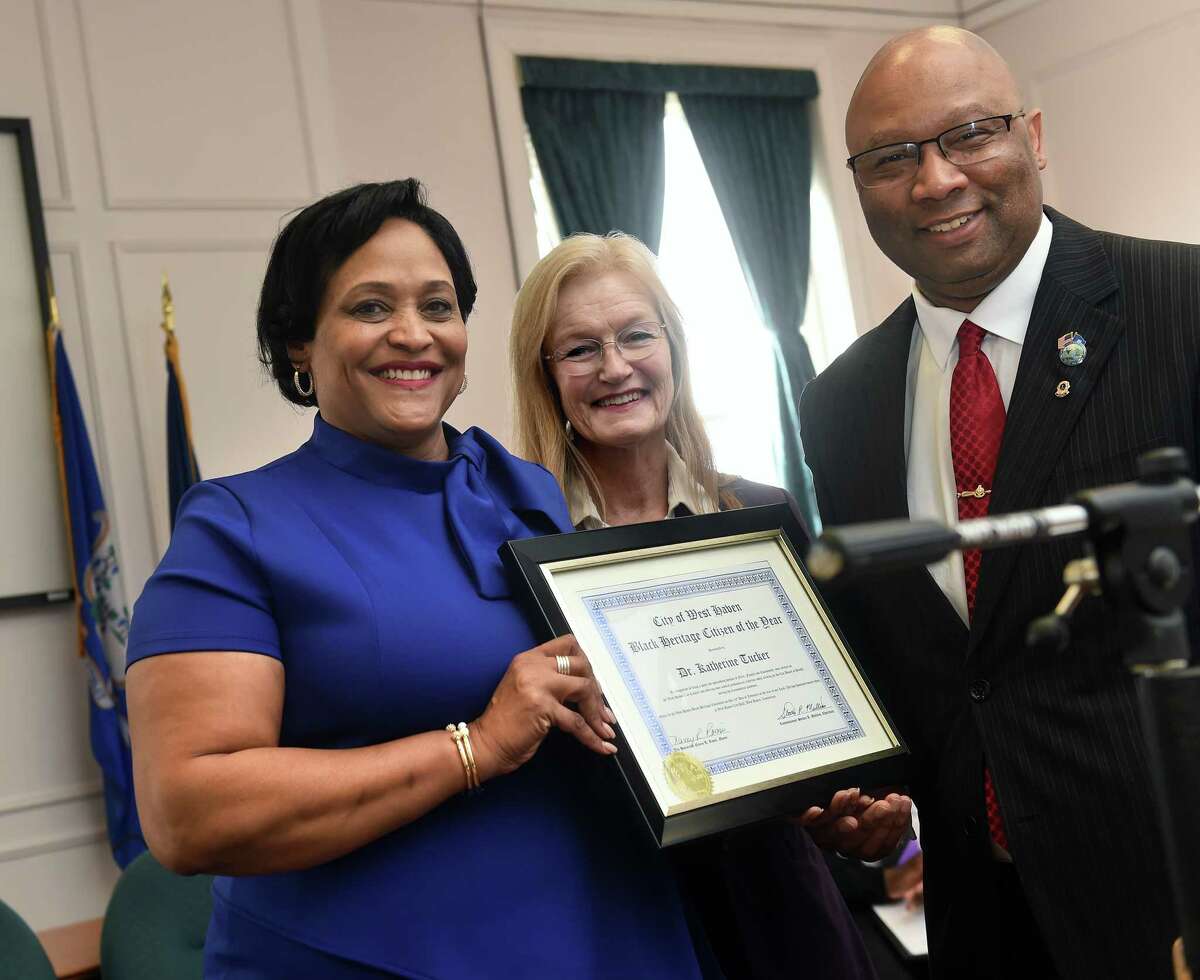 From left, Dr. Katherine Tucker is honored as the 2023 Black Heritage Citizen of the Year by West Haven Mayor Nancy Rossi and West Haven Black Heritage Committee Chairman Steven R. Mullins during the 27th annual Black Heritage Celebration at City Hall Thursday.