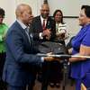Rev. E. Carl Howard, left, presents Dr. Katherine Tucker with a custom embroidered jacket in honor of being named the 2023 Black Heritage Citizen of the Year during the 27th Annual Black Heritage Celebration at West Haven City Hall on February 16, 2023. Howard received the honor in 2022.