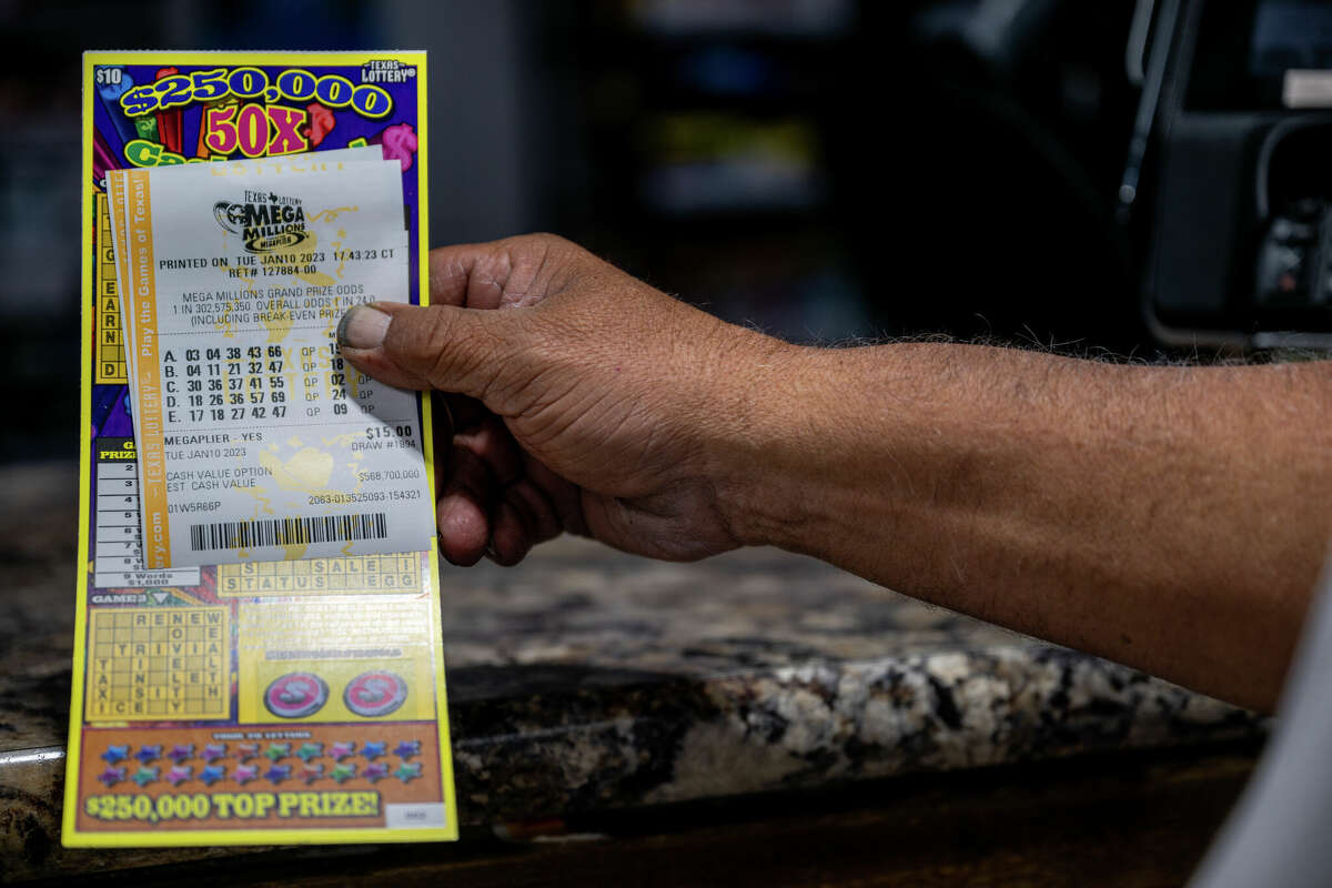 A customer showcases his purchased lottery ticket at a CITGO gas station on January 10, 2023 in Austin, Texas. The Mega Millions jackpot has climbed to $1.1 billion ahead of today's drawing.