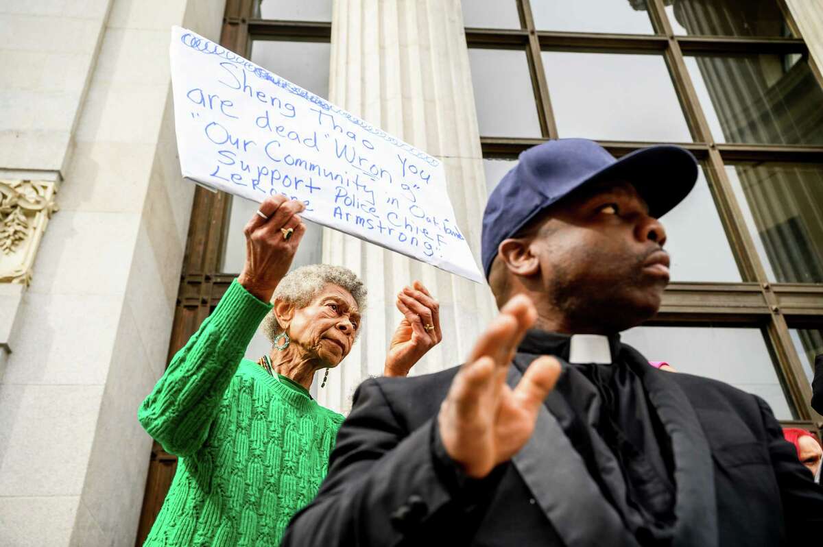 Rosalind Patton holds a sign supporting fired Oakland Police Chief LeRonne Armstrong during a rally outside city hall on Thursday, Feb. 16, 2023, in Oakland.