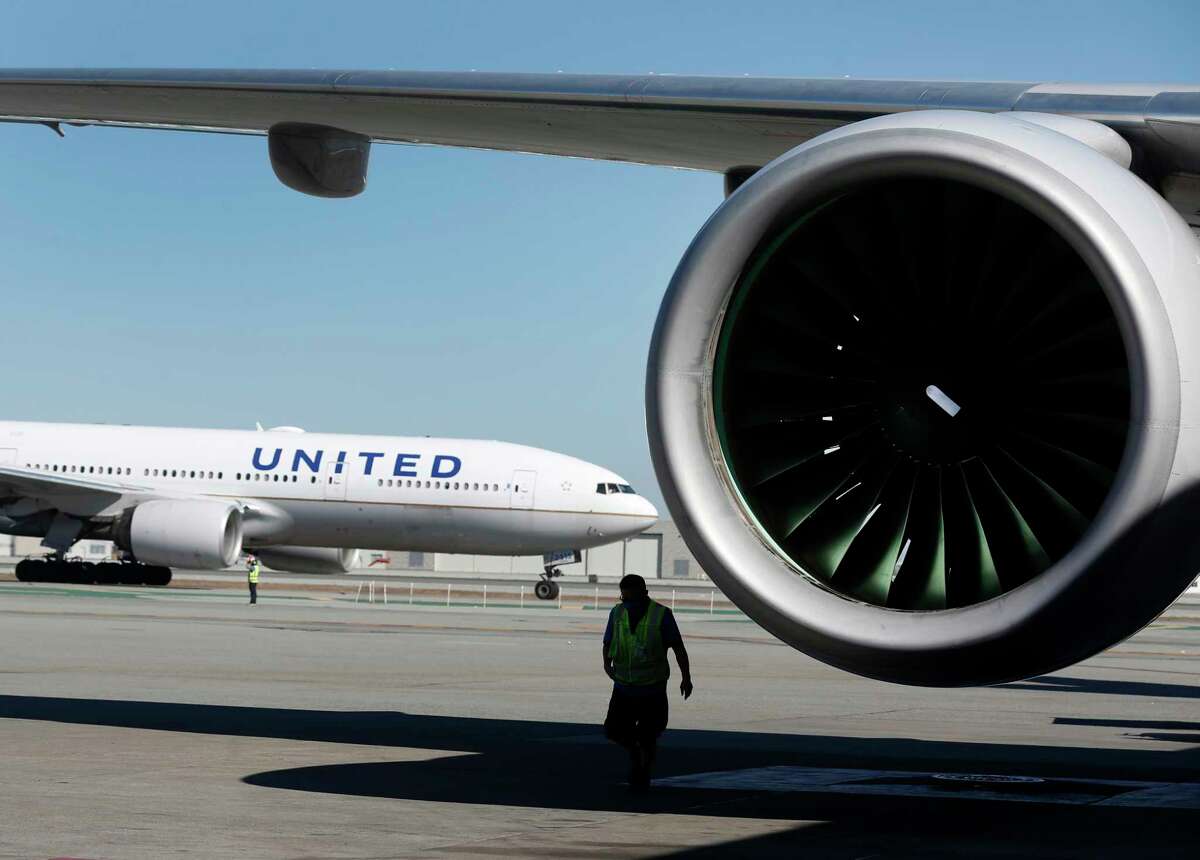 A United Airlines Boeing 777 is readied for departure to Honolulu from gate F11 as another plane taxis to the runway at SFO in San Francisco, Calif. A passenger aboard a United flight that nosedived after taking off from Maui recounted the harrowing experience. 