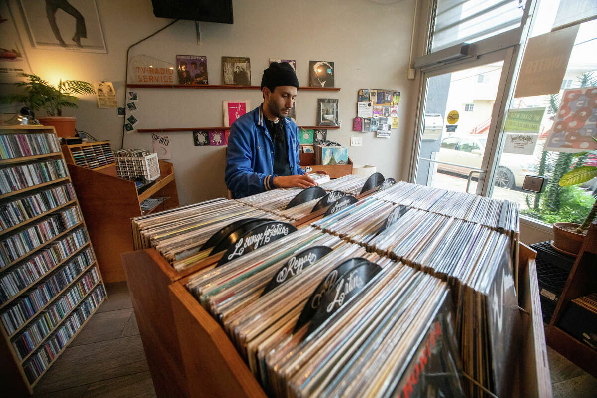 Ed Chavez peruses the record collection at Hercules Records in Berkeley, Calif. on Feb. 14, 2023.