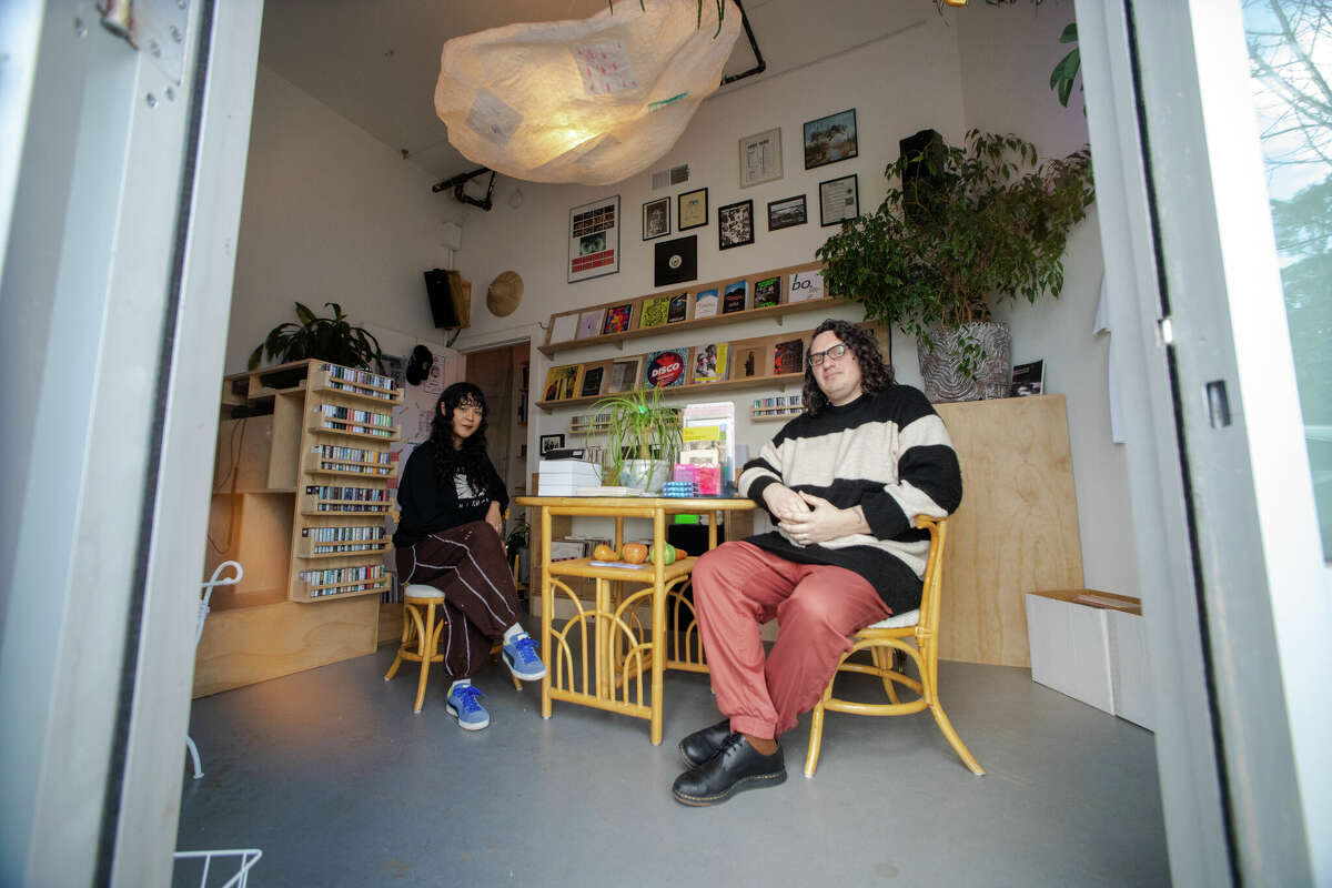(Left to right) Cat Lauigan and Matt Brownellsit inside their compact record store, Cone Shape Top in Oakland, Calif. on Feb. 14, 2023.