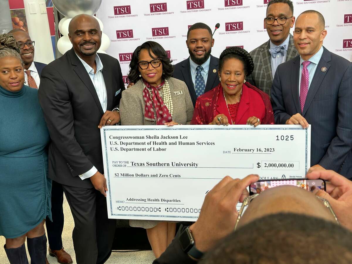 House Minority Leader Hakeem Jeffries, D-New York, far right, and U.S. Rep Sheila Jackson Lee, D-Houston, third from the right, stand with Texas Southern University leaders on Feb. 16, 2023 to hold a check representing a $2 million federal grant for the university to study health equity in Third Ward.