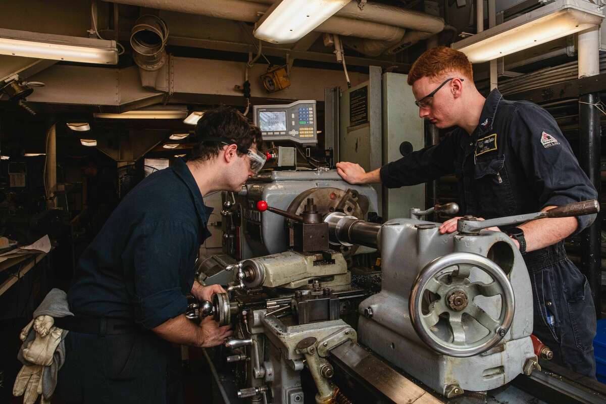 Navy Machinery Repairman 2nd Class Shawn Vena, right, of Niskayuna,, and Machinery Repairman Fireman Justin Wilkins of La Grange, Ky., grind metal aboard the aircraft carrier USS Nimitz (CVN 68) in the South China Sea. 